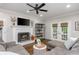 Comfortable living room with a fireplace, ceiling fan, and access to the outdoors through French doors at 1161 Arborhill Dr, Woodstock, GA 30189