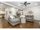 Open-concept living room featuring hardwood floors and a large sectional sofa, ideal for entertaining at 1161 Arborhill Dr, Woodstock, GA 30189