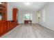 Spacious living room with wood floors, large windows, built-in cabinets, and neutral paint at 1161 Arborhill Dr, Woodstock, GA 30189