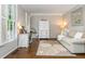 Cozy living room featuring light gray walls, hardwood floors, and abundant natural light through shuttered windows at 1161 Arborhill Dr, Woodstock, GA 30189
