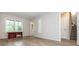 Bright, open living room featuring wood floors, large windows, and access to a bathroom and stairs at 1161 Arborhill Dr, Woodstock, GA 30189