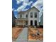 Charming two-story home with white siding, black framed windows, and a welcoming front porch at 3482 Adler Trl, Buford, GA 30519