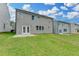 The backyard has green grass and a patio with double doors at 3968 Annsbury Court, Lilburn, GA 30047