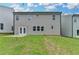 A backyard featuring a graded lawn and a patio with double doors at 3968 Annsbury Court, Lilburn, GA 30047