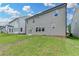 Backyard featuring a graded lawn and patio with glass paneled doors at 3968 Annsbury Court, Lilburn, GA 30047