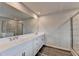 Bathroom showcasing a dual sink vanity and a glass-enclosed shower with tile surround at 3968 Annsbury Court, Lilburn, GA 30047