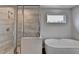 Bathroom featuring a glass-enclosed shower with tile surround and a soaking tub at 3968 Annsbury Court, Lilburn, GA 30047