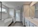Bright bathroom with soaking tub, dual vanity, and tile flooring at 3968 Annsbury Court, Lilburn, GA 30047