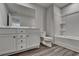 Bathroom featuring double sink vanity, wood look flooring, and a shower-tub combo at 3968 Annsbury Court, Lilburn, GA 30047