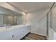 Bathroom featuring a dual sink vanity and a glass-enclosed shower with tile surround at 3968 Annsbury Court, Lilburn, GA 30047