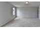 Carpeted bedroom featuring a light-filled window and neutral wall color at 3968 Annsbury Court, Lilburn, GA 30047