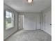 Bright, carpeted bedroom features natural light, neutral tones, and convenient access to multiple rooms through elegant doorways at 3968 Annsbury Court, Lilburn, GA 30047