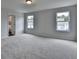 Sunlit carpeted bedroom with a tranquil ambiance, featuring two windows and a glimpse into an en-suite bathroom at 3968 Annsbury Court, Lilburn, GA 30047