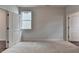 Carpeted bedroom featuring a double door closet, a window, and adjacent room entrances at 3968 Annsbury Court, Lilburn, GA 30047