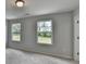 Serene bedroom illuminated by natural light through two windows, boasting plush carpet and a calming, neutral color scheme at 3968 Annsbury Court, Lilburn, GA 30047