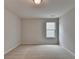 Neutral bedroom featuring plush carpet and a window providing natural light at 3968 Annsbury Court, Lilburn, GA 30047