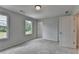 Well-lit bedroom with natural light from two windows, featuring plush carpet and convenient access to a bathroom at 3968 Annsbury Court, Lilburn, GA 30047