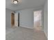 A bedroom featuring an open closet door and plush carpet floors at 3968 Annsbury Court, Lilburn, GA 30047