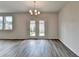 Dining area featuring hardwood floors and access to the backyard through glass doors at 3968 Annsbury Court, Lilburn, GA 30047