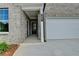 Close up shot of the front entrance with brickwork and an attached two-car garage on the right at 3968 Annsbury Court, Lilburn, GA 30047