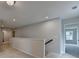 Well-lit hallway features neutral tones and smooth carpet, connecting various rooms with a clean and modern aesthetic at 3968 Annsbury Court, Lilburn, GA 30047