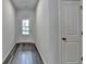 Bright entryway with hardwood floors leading to a glass door and a white interior door on the right at 3968 Annsbury Court, Lilburn, GA 30047