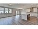 Open-concept kitchen and living area featuring stainless steel appliances and hardwood flooring at 3968 Annsbury Court, Lilburn, GA 30047