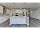Open kitchen featuring a large island with a sink, stainless steel appliances, and hardwood floors at 3968 Annsbury Court, Lilburn, GA 30047