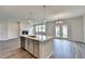 Kitchen island with sink and dishwasher, open to a living area with a fireplace and access to the backyard at 3968 Annsbury Court, Lilburn, GA 30047