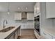 Modern kitchen featuring stainless steel appliances, a kitchen island with a sink, and neutral colors at 3968 Annsbury Court, Lilburn, GA 30047