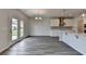 Open kitchen with white cabinets, stainless appliances, and wood flooring at 3968 Annsbury Court, Lilburn, GA 30047