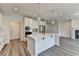 Well-lit kitchen with a spacious island, stainless steel appliances, and hardwood floors at 3968 Annsbury Court, Lilburn, GA 30047