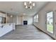 Open-concept living area featuring a fireplace, hardwood floors, and a kitchen with an island at 3968 Annsbury Court, Lilburn, GA 30047
