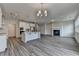 Spacious living area featuring a fireplace, hardwood floors, an island kitchen and natural lighting at 3968 Annsbury Court, Lilburn, GA 30047