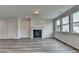 Bright living room with fireplace, large windows, and gray wood-look floors at 3968 Annsbury Court, Lilburn, GA 30047
