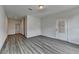 Bright living room featuring wood-look flooring, light walls, and a door to the outside at 3968 Annsbury Court, Lilburn, GA 30047
