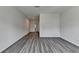 Open living room showcasing light gray walls and modern wood-look flooring at 3968 Annsbury Court, Lilburn, GA 30047