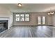 Open floor plan with fireplace, wood floors, and outdoor access at 3968 Annsbury Court, Lilburn, GA 30047