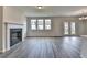 Living room with fireplace, wood floors, and natural light at 3968 Annsbury Court, Lilburn, GA 30047