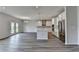 Open floor plan with island kitchen, stainless appliances, and wood flooring at 3968 Annsbury Court, Lilburn, GA 30047