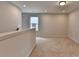 Bright loft area with plush carpeting, enhanced by natural light from a window, offers a versatile living space at 3968 Annsbury Court, Lilburn, GA 30047