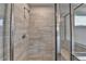 Close-up of shower with glass enclosure and beige-tiled walls at 3968 Annsbury Court, Lilburn, GA 30047