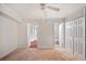 Spacious bedroom with carpet, ceiling fan, closet, and adjoining bathroom offers comfort and convenience at 5400 Roswell Rd # L-3, Atlanta, GA 30342