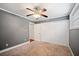 This bedroom has soft carpeting, a ceiling fan, a window, and a closet for storage at 5400 Roswell Rd # L-3, Atlanta, GA 30342