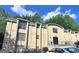 A multi-story apartment building with brick facade and ample tree coverage surrounding the building at 5400 Roswell Rd # L-3, Atlanta, GA 30342