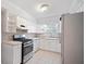 Bright kitchen with white cabinetry, tile backsplash, and stainless steel appliances at 5400 Roswell Rd # L-3, Atlanta, GA 30342