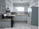 Kitchen featuring tile countertops, white appliances and cabinets at 5400 Roswell Rd # L-3, Atlanta, GA 30342
