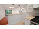 Open kitchen area with tiled floors, countertops, and a view into the adjacent living room at 5400 Roswell Rd # L-3, Atlanta, GA 30342