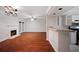 Inviting living room featuring a fireplace, wood floors, and an open bar area leading to the kitchen at 5400 Roswell Rd # L-3, Atlanta, GA 30342