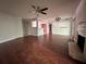 Living room with dark hardwood floors, ceiling fan, and view into the kitchen at 5400 Roswell Rd # L-3, Atlanta, GA 30342